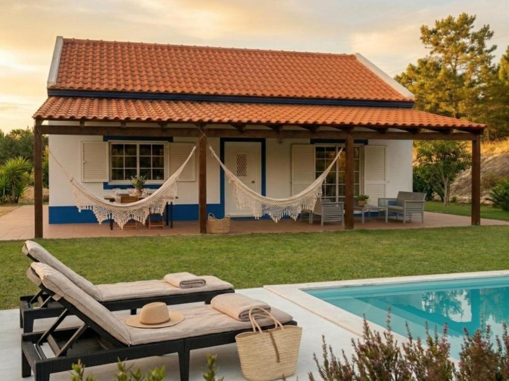 a villa with a swimming pool and a house at Casa do Arrozal Comporta in Comporta