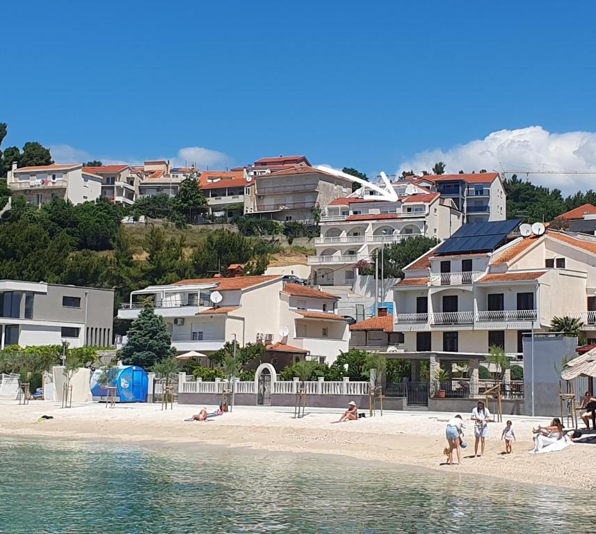 a group of people on a beach near the water at SmartStay Johnny in Podstrana