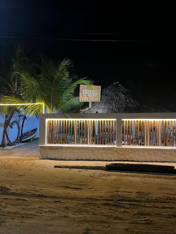 a fence with lights on it on the beach at night at Boutique Playa DanRay in La Perdiz