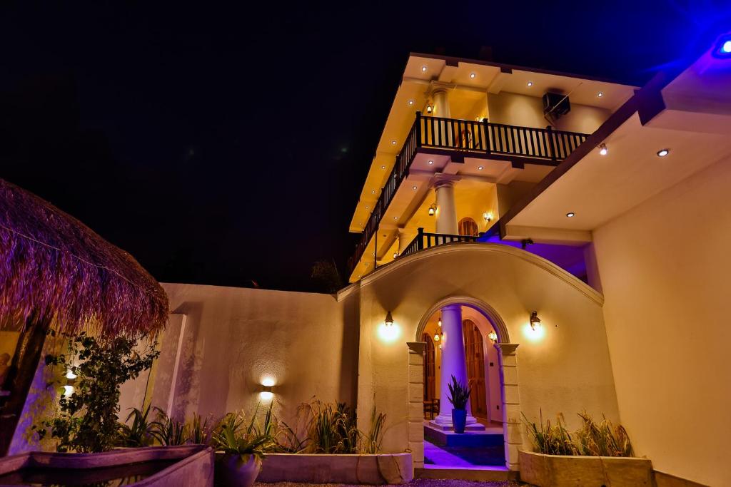 a night view of a house with purple lights at King Palace Mirissa in Mirissa