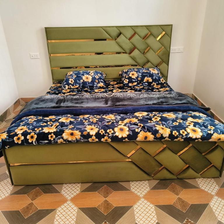 a bedroom with a large bed with flowers on it at Supreme Lake in Srinagar