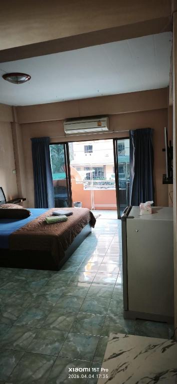a bedroom with a bed and a television in it at Redbull guest house in Pattaya