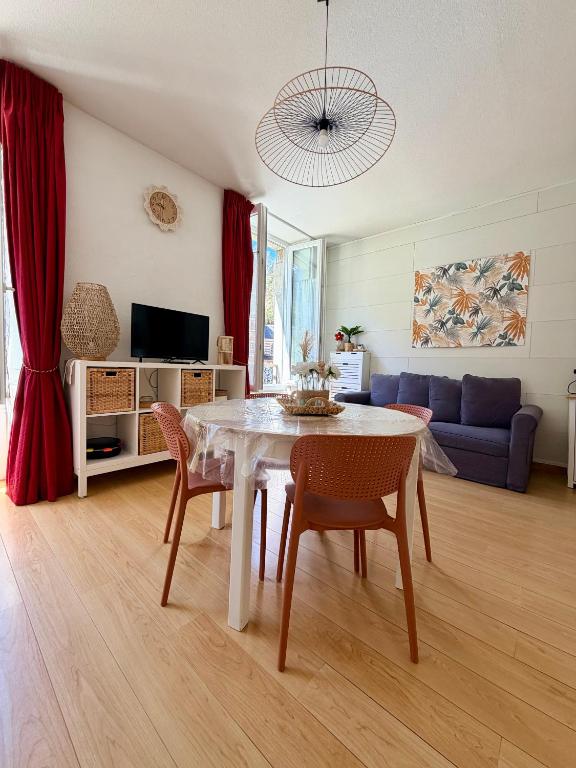 a living room with a table and a couch at Le Nid Ossalois in Eaux-Bonnes