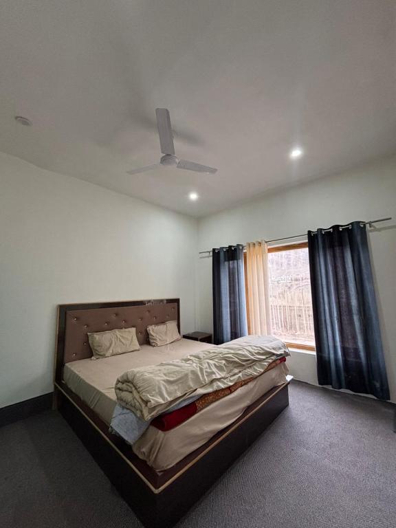 a bedroom with a bed and a window at Dod gu Yongs Khil in Karu
