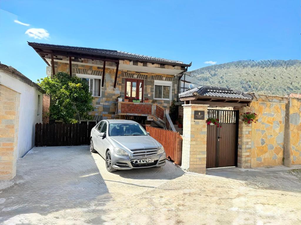 a silver car parked in front of a house at Citrus Nest in Berat