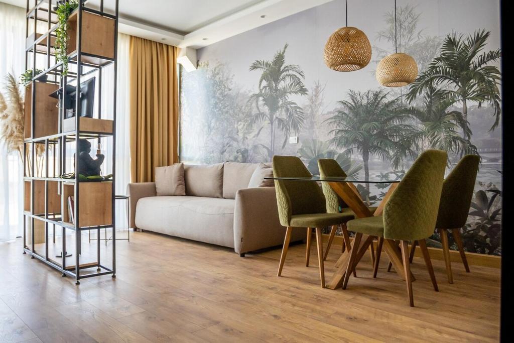 a living room with a couch and a table and chairs at Apartment Jungle in Belgrade