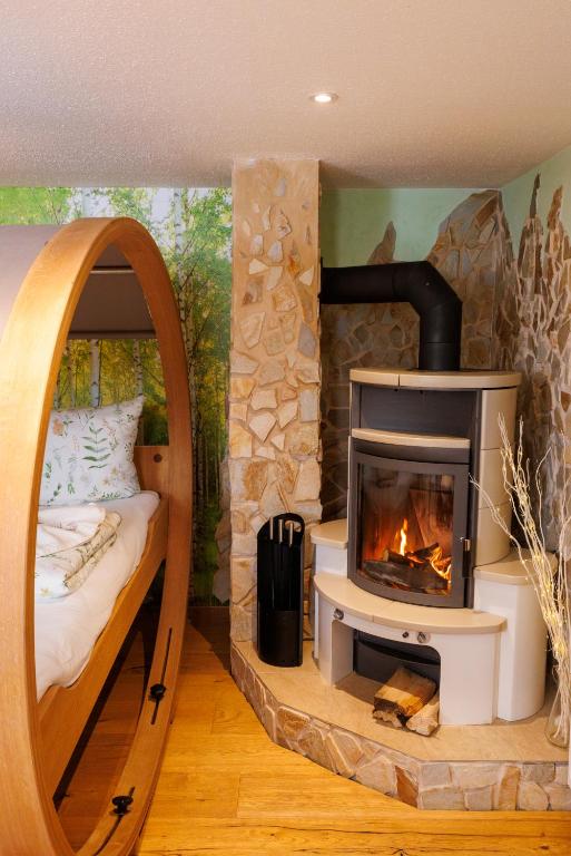 a bed and a fireplace in a room at BioNestlein Premium Apartments mit Biosauna, Wintergarten & exklusiver Bio-Verpflegung in Löffingen