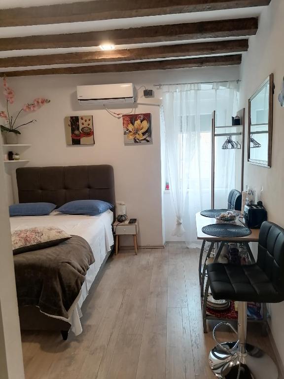 a bedroom with a bed and a table in it at D & G in Split
