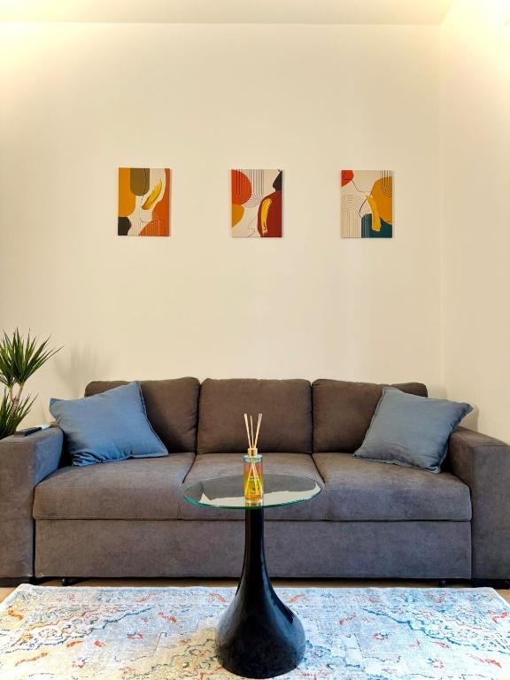 a living room with a couch and a table at AlexBnB in Turin