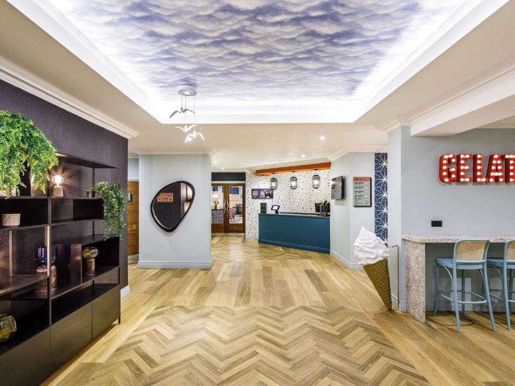 a room with a ceiling with a cloud mural at ibis Styles Bournemouth in Bournemouth