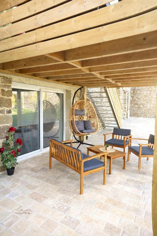 a patio with two benches and a swing at La Manch'hôtes in Domjean