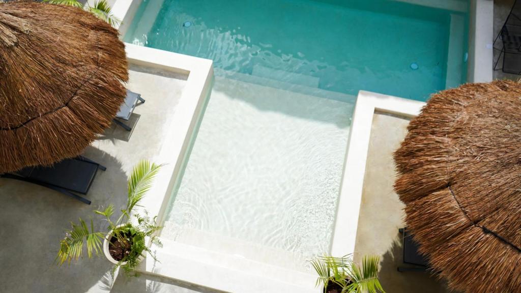 an overhead view of a house with a blue door at Hotel Diosa del Agua Bacalar in Bacalar
