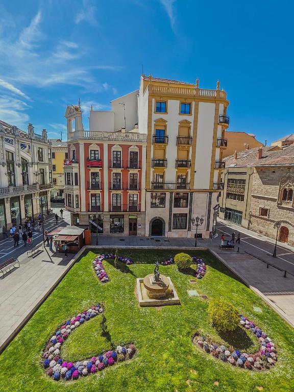 a courtyard with a fountain in the grass in front of a building at Apartamento CENTRO HISTÓRICO Zorrilla 4 in Zamora