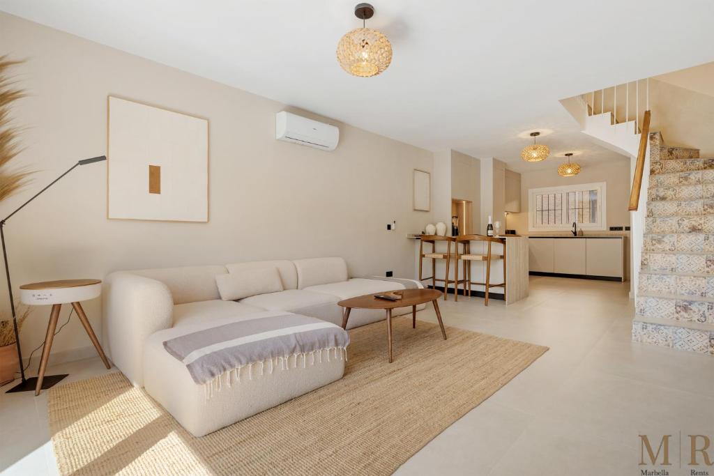 a living room with a white couch and a table at Casa Eva Ref #97 in Estepona