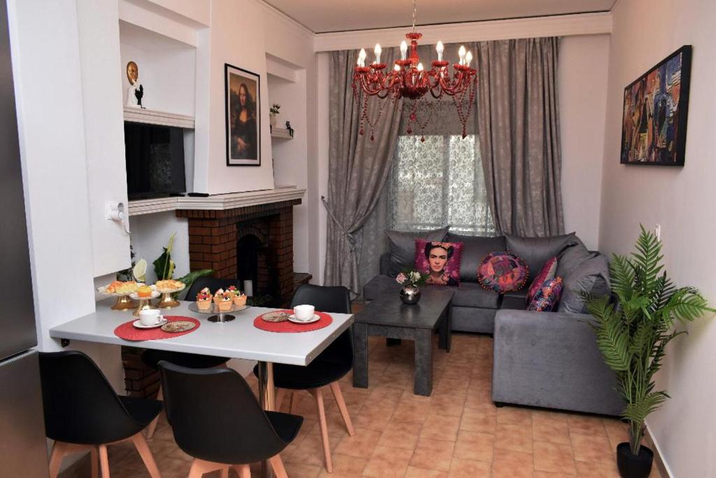 a living room with a couch and a table at Art House by Helen in Soroni Rhodes in Rhodes Town
