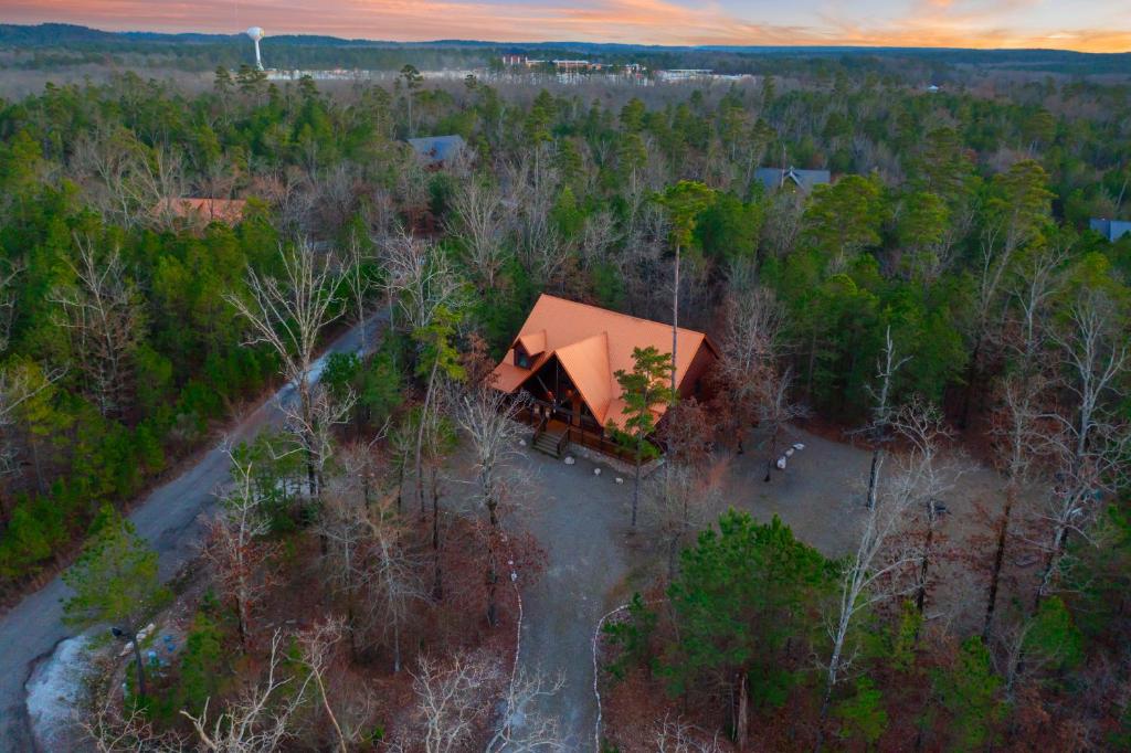 an aerial view of a house in the woods at Wide Glide Lodge - In-home Movie Room, Hot Tub and Large 1-acre property with Playset in Broken Bow