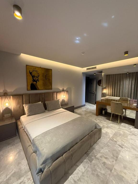 a bedroom with a large bed and a desk at The Pilgrim Ephesus Hotel in Selçuk