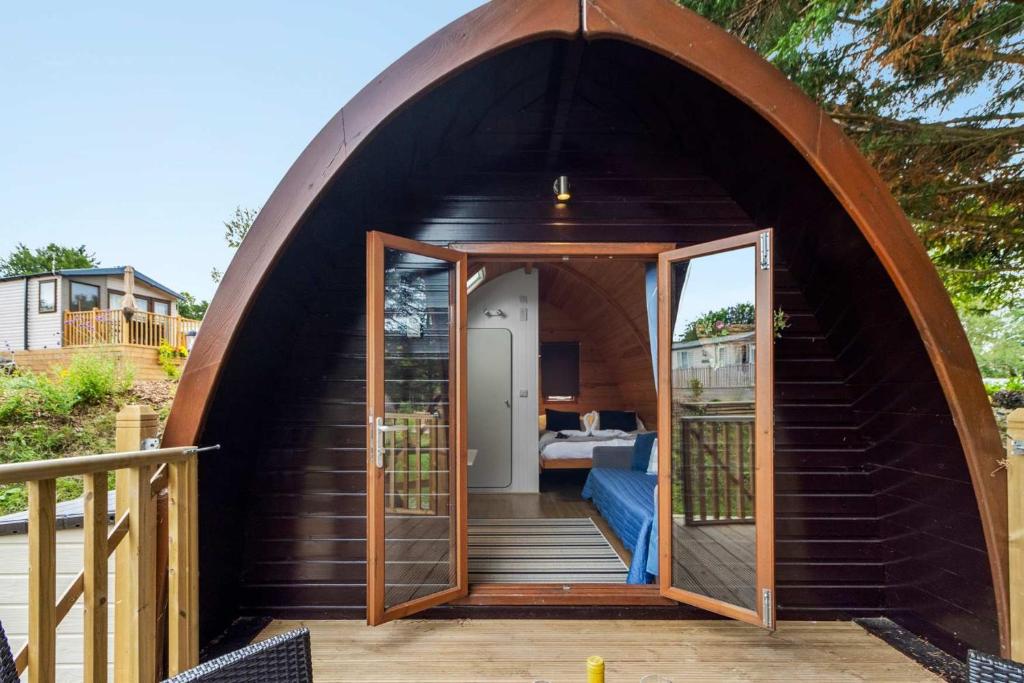 a dome house with a staircase in a backyard at Lakeside Nest - Fishing Lakes, Heated Outdoor Swimming Pool 500yrds on Sister Park , Pool Open May to September in Exeter