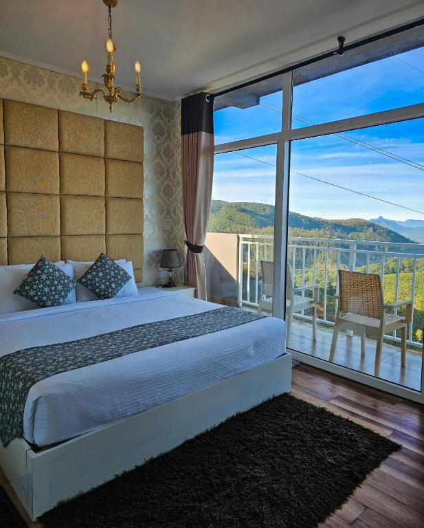 a bedroom with a bed and a large window at Hotel Bonavista in Nuwara Eliya
