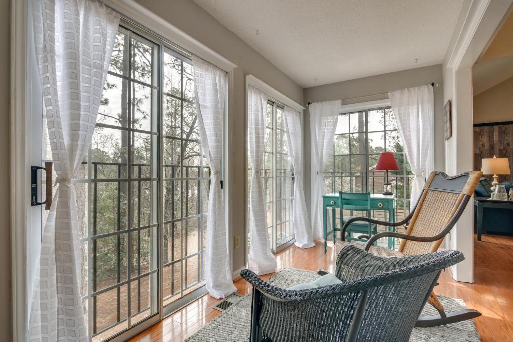a room with windows and a chair and a desk at Pinehurst Condo ~ 2 Miles to Downtown & Resort! in Pinehurst