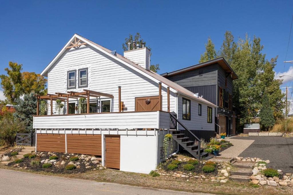 a white house with a garage at The Disco Chalet in Steamboat Springs