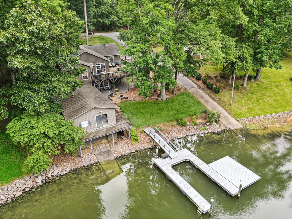 an aerial view of a house with a dock in the water at Pool Table, Massive Balcony, Firepit, & Spacious! in Sherrills Ford