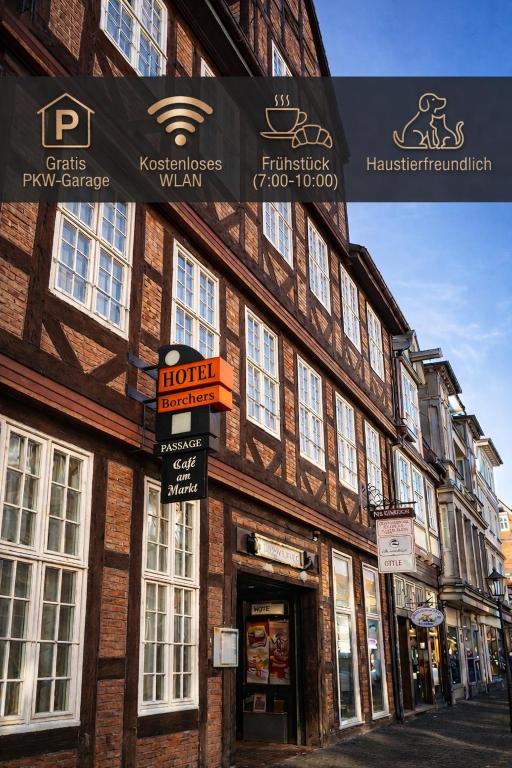 a building on a street with signs on it at Hotel Borchers in Celle
