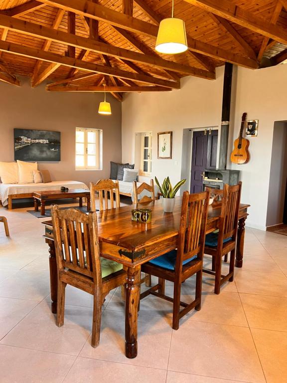 a dining room with a wooden table and chairs at Garys Old Farmhouse in Kamária