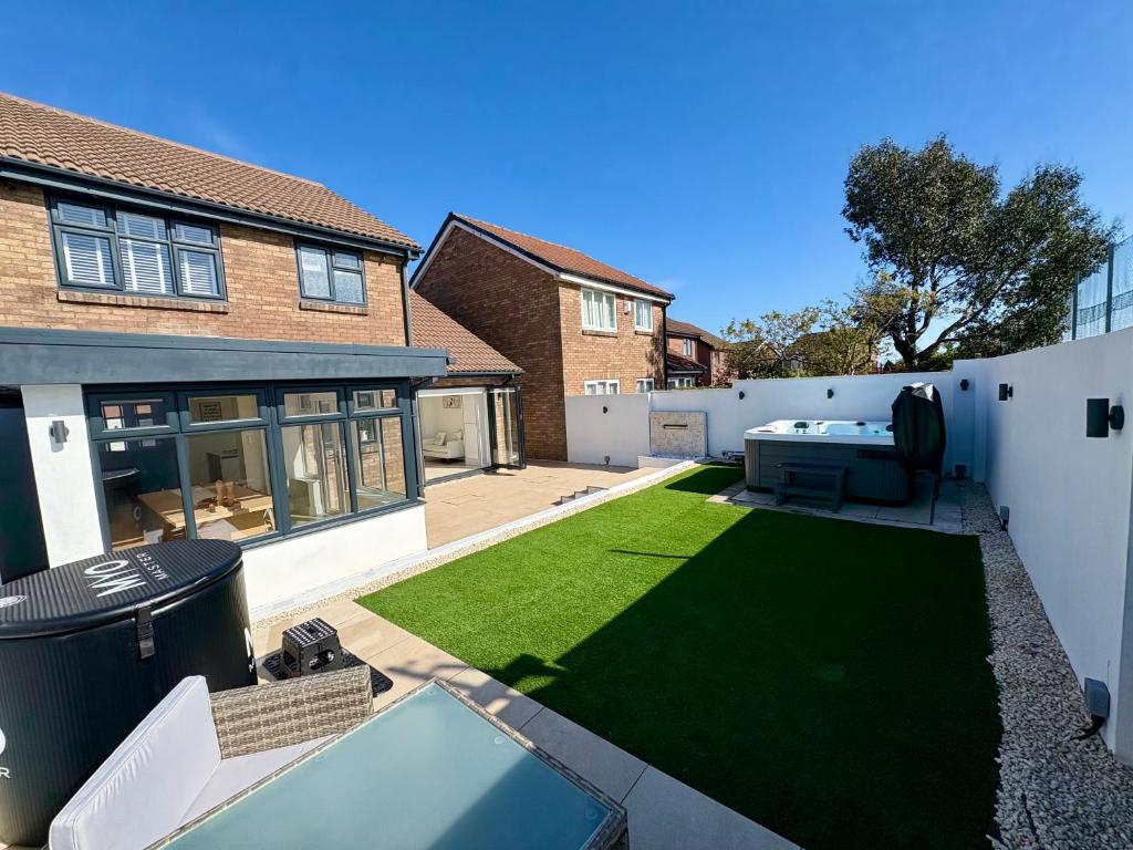 a backyard with a pool table and a lawn at Santíago Retreat in Wenvoe