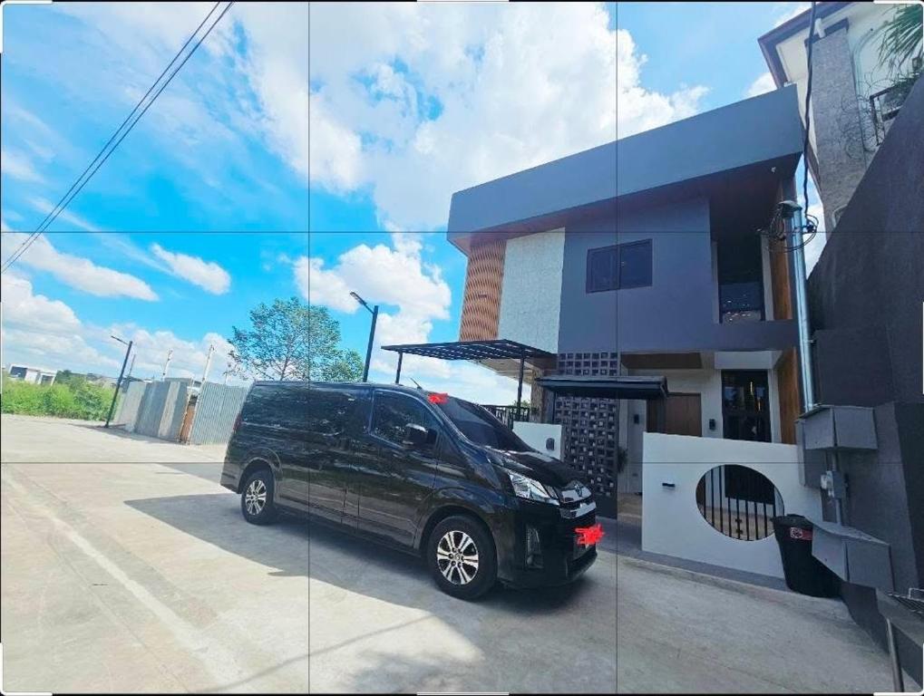 a black van parked in front of a building at Villa Cassandra Atasha Private Resort - Celestine in Cuayan