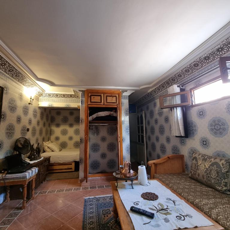 a living room with a couch and a table at Momo's villa in Aït Ourir