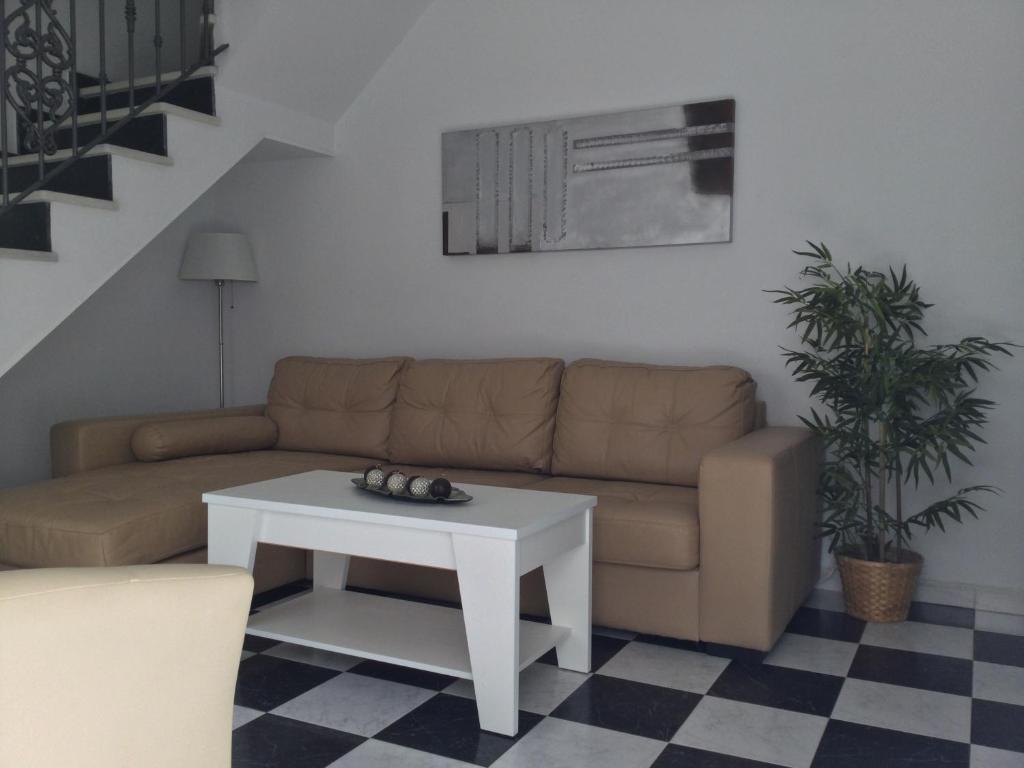a living room with a couch and a table at Isabella Chipiona in Chipiona