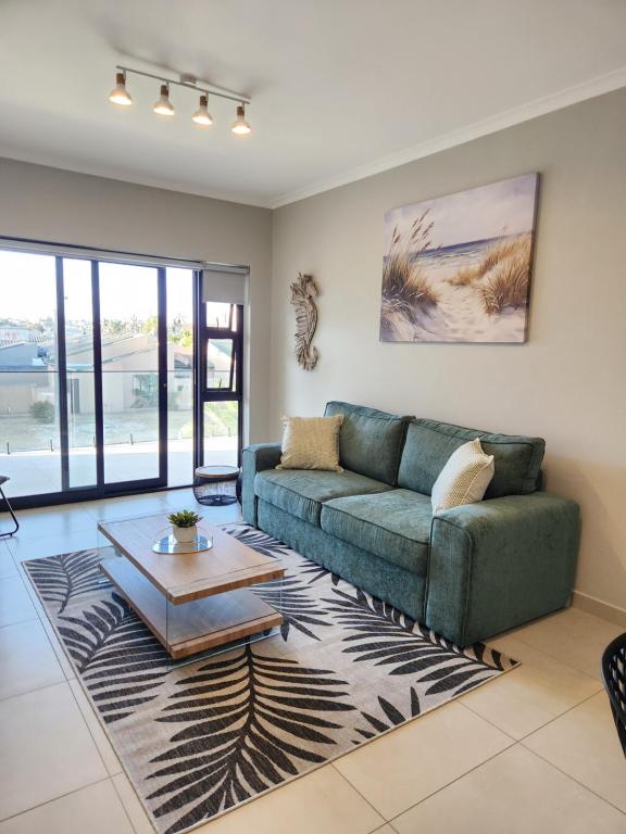 a living room with a couch and a table at Beach Haus Unit 1 in Cape Town