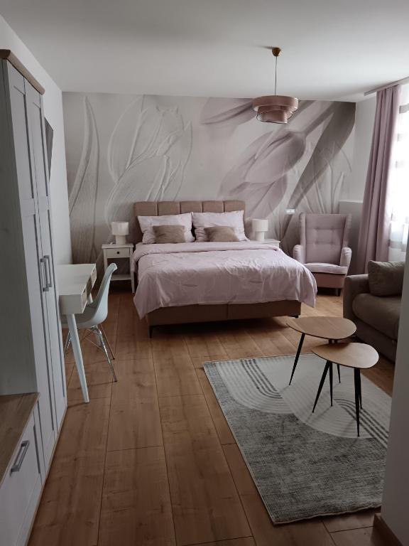 a bedroom with a bed and a living room at Guest House Klaudija in Trogir