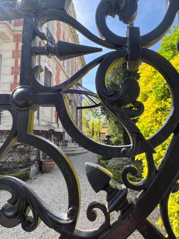 a close up of a wrought iron fence at La HALTE des CAVALIERS in Compiègne
