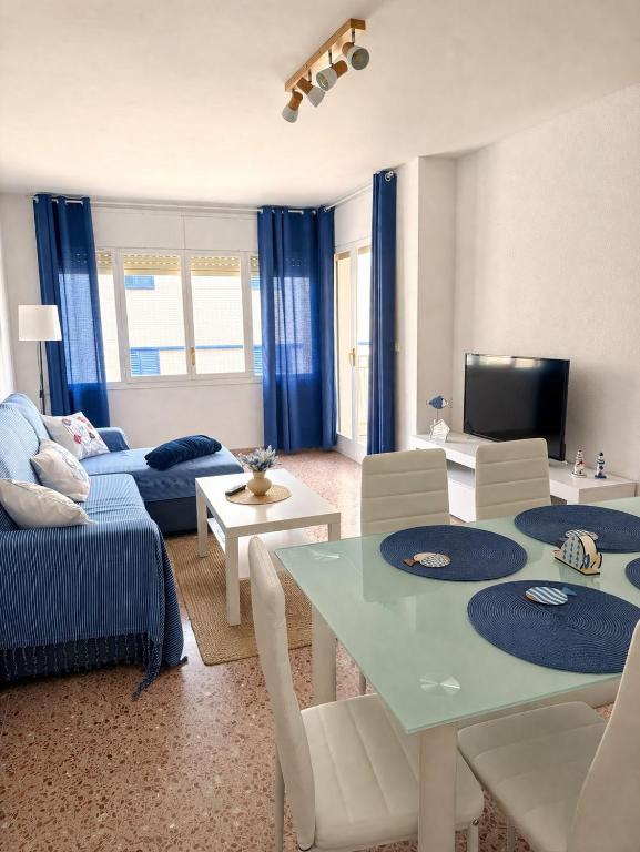 a living room with a couch and a table at Ocean Breath Home in L'Ametlla de Mar