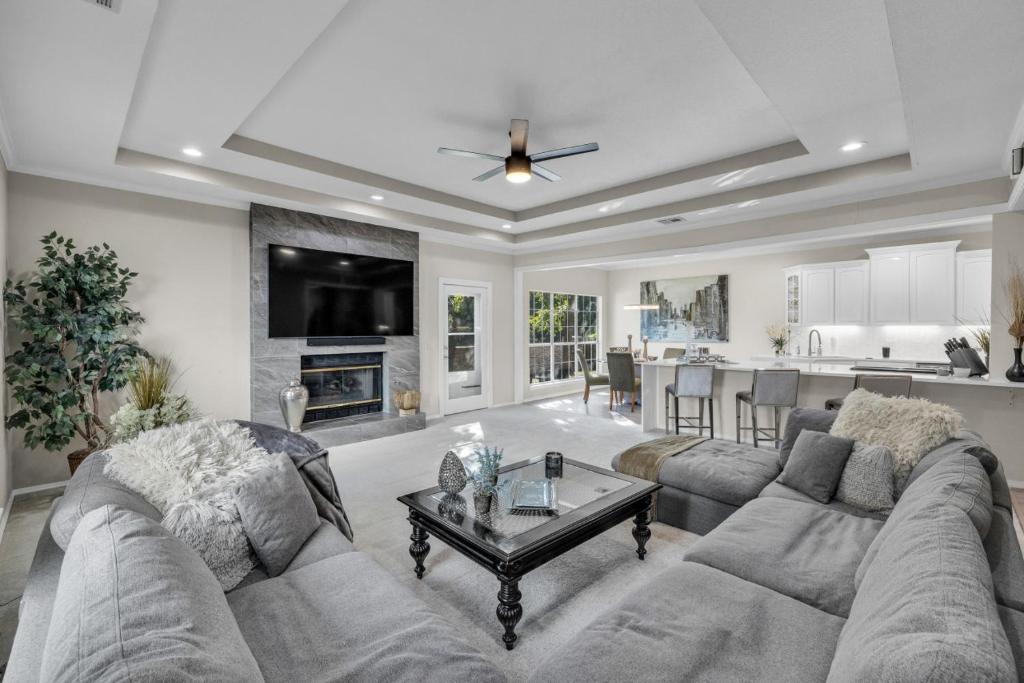 a large living room with a couch and a table at The Tulsacation on Oxford in Tulsa