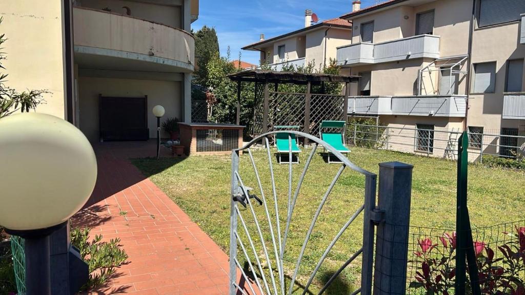 a playground in a yard next to a building at Casa Serena in Donoratico