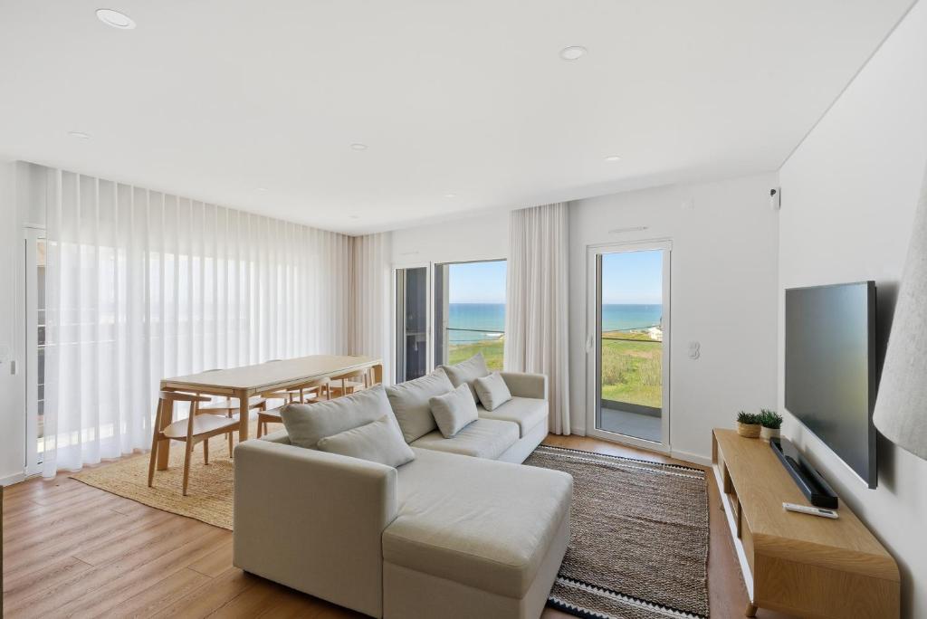 a living room with a couch and a table at Atlantic Apartments in Santa Cruz