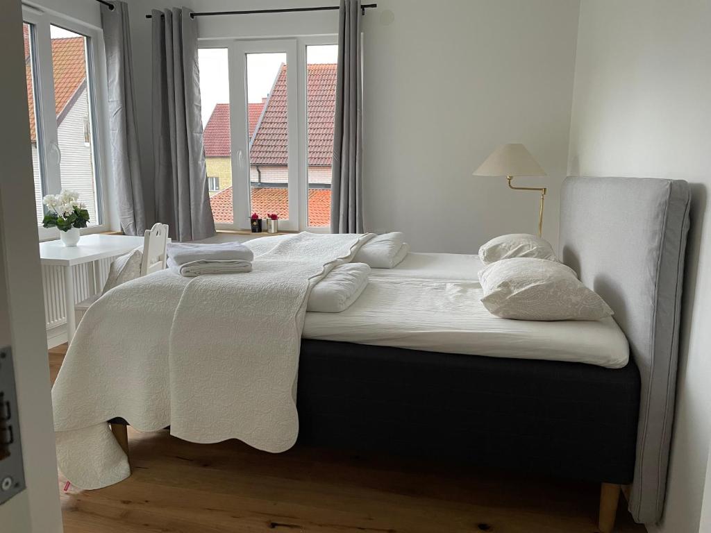 a bed in a room with a large window at Ruddbecksgatan AA in Eskilstuna