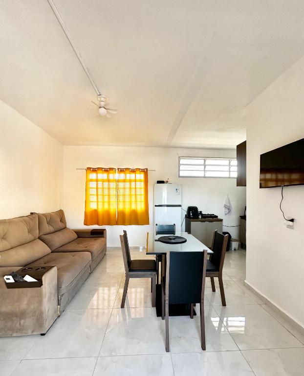 a living room with a couch and a table at CasaMara in Ribeirão Preto