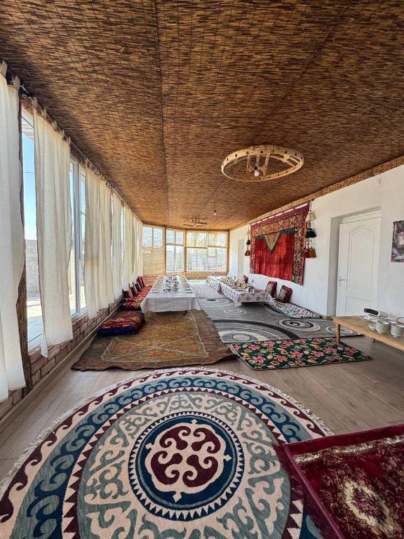 a large living room with a large rug on the floor at Nukura in Bokonbayevo
