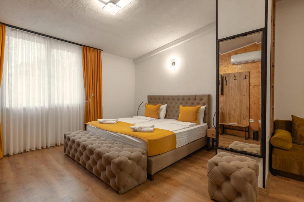 a bedroom with a bed and a large window at Hotel Domestika in Skopje