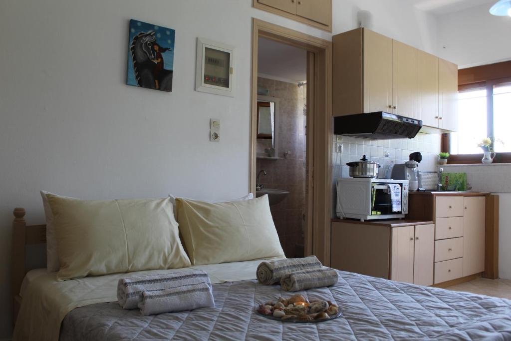 a bedroom with a bed with a tray of food on it at Vakis Apartments 2 in Romanón
