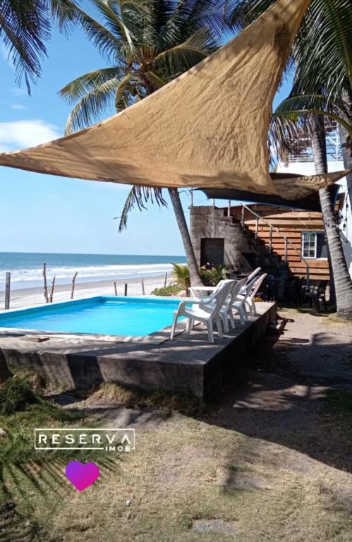 a resort with a swimming pool and the beach at Ranchito Cornejo in La Esmeralda