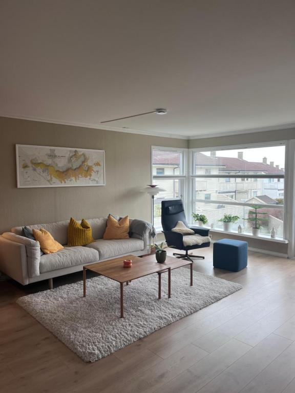 a living room with a couch and a table and a chair at 2 minute walk from ONS exhibiton area in Stavanger