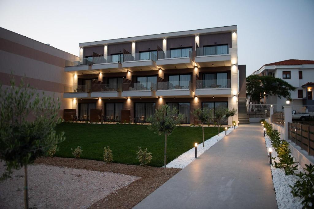 a building with lights on the side of it at Sithonian Sunset Luxury Apartments in Skála Nikíta