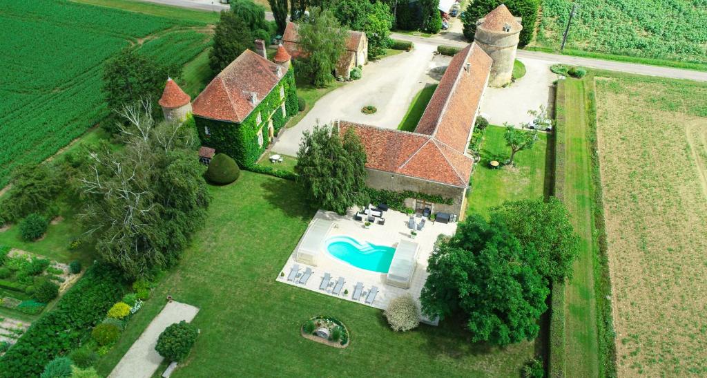 an aerial view of a house with a swimming pool at Château de Ribourdin in Chevannes
