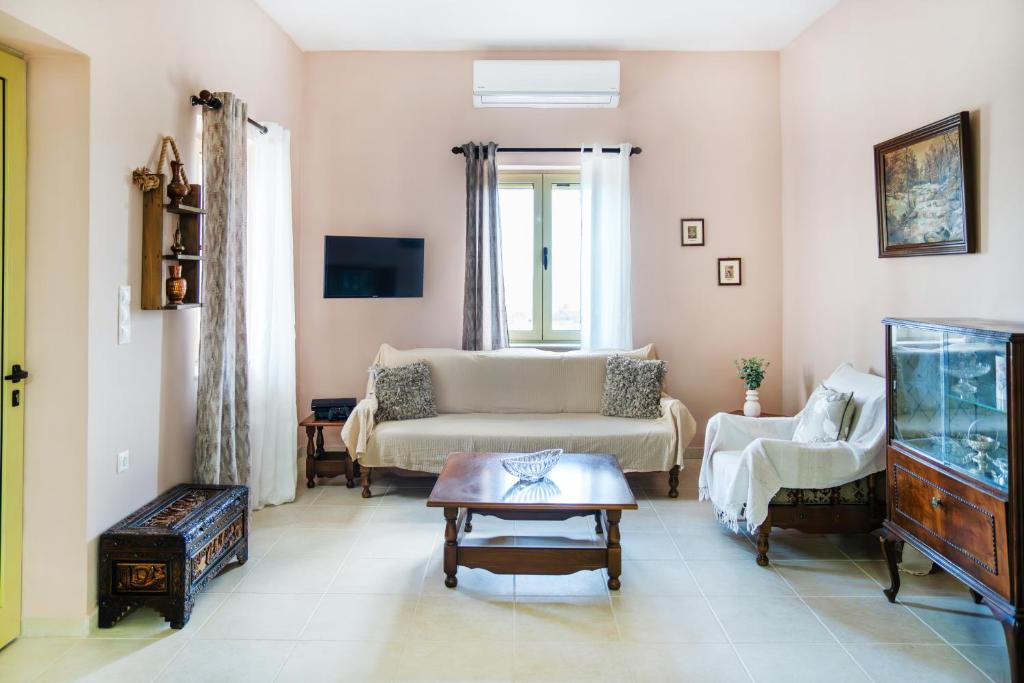 a living room with a couch and a fish tank at Oliva Mare I in Agia Fotia