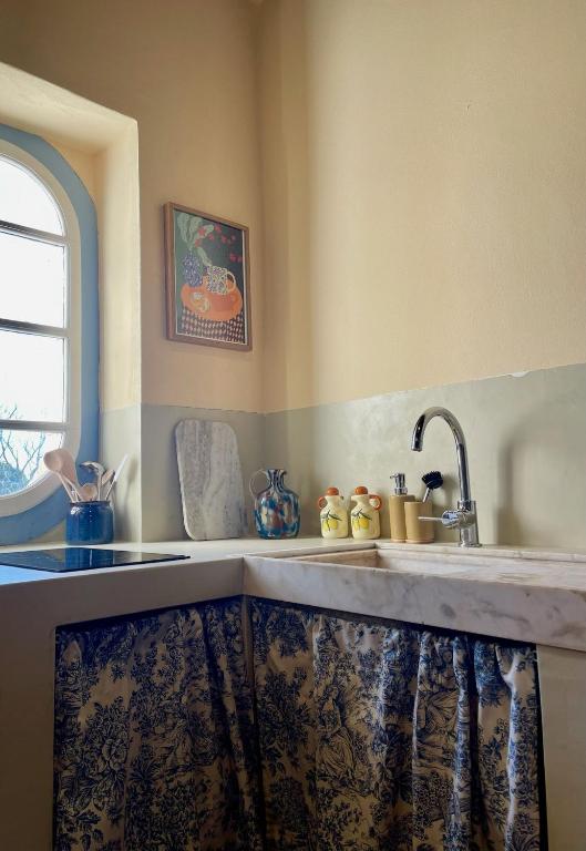 a kitchen counter with a sink and a window at Casa Terra in Rio Maior